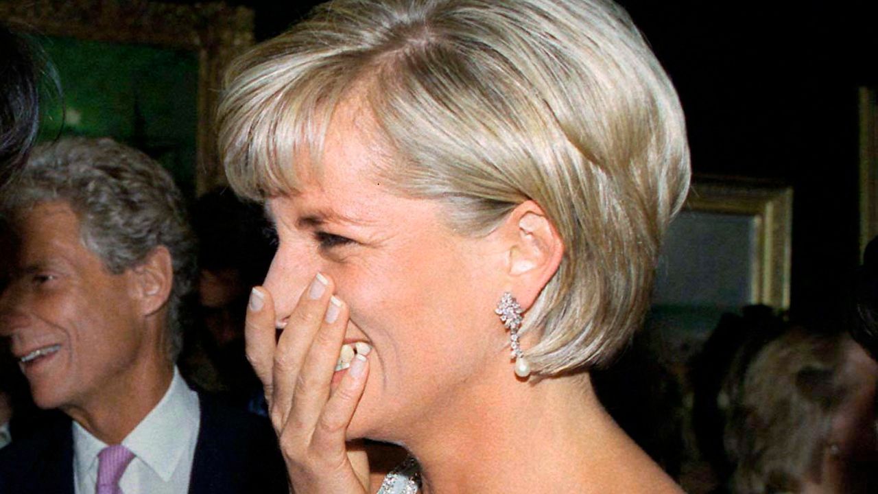 Princess Diana covering her mouth and laughing