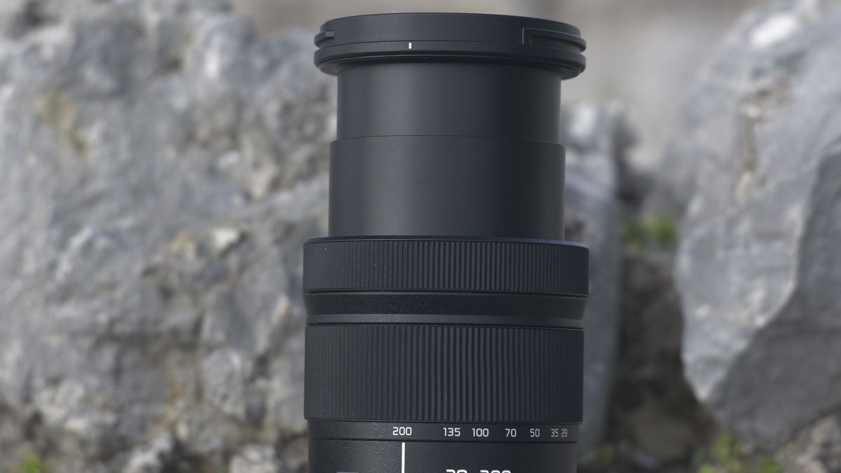 Panasonic LUMIX S 28-200mm F4-7.1 MACRO lens on a rock with lens zoom expanded