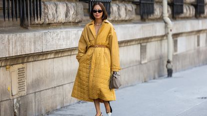 woman wearing a long yellow down jacket