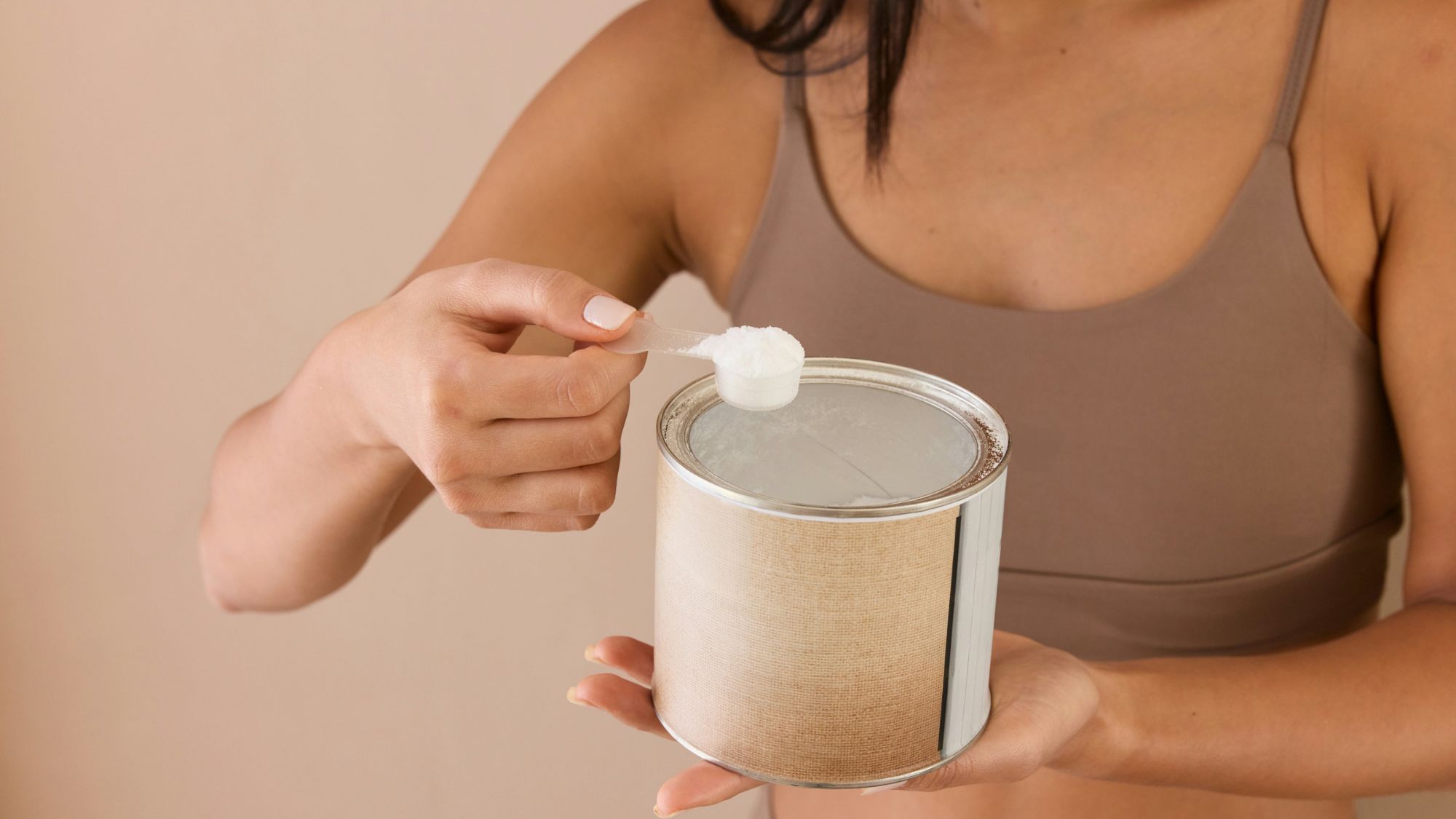 woman scooping workout powder