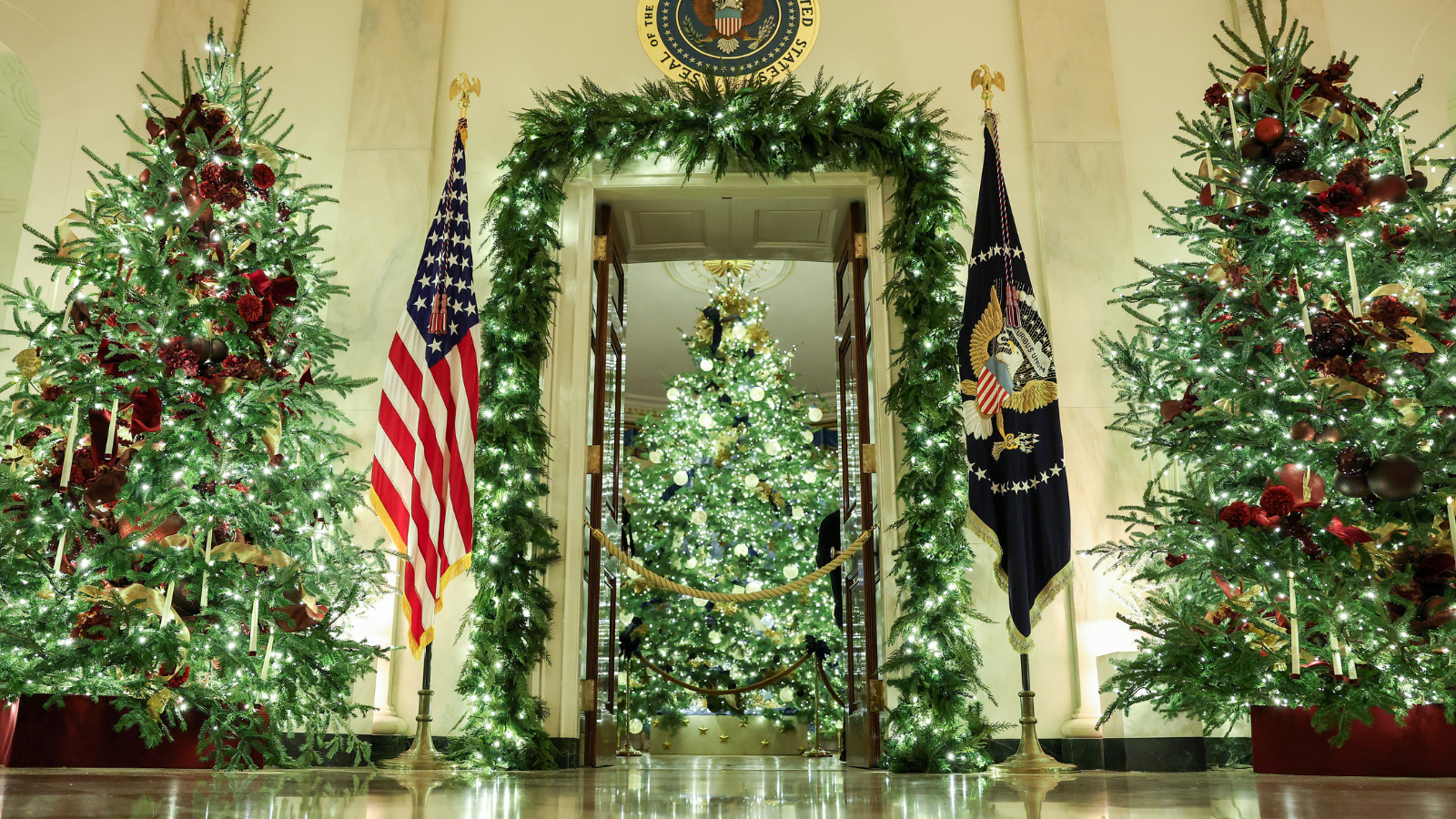 Christmas trees and holiday decorations surround the Cross Hall during an advance tour of the 2025 White House Christmas decorations on December 01, 2025 in Washington, DC. The theme for this year&#039;s White House Christmas decorations is &quot;Home Is Where The Heart Is.&quot; (Photo by Anna Moneymaker/Getty Images)