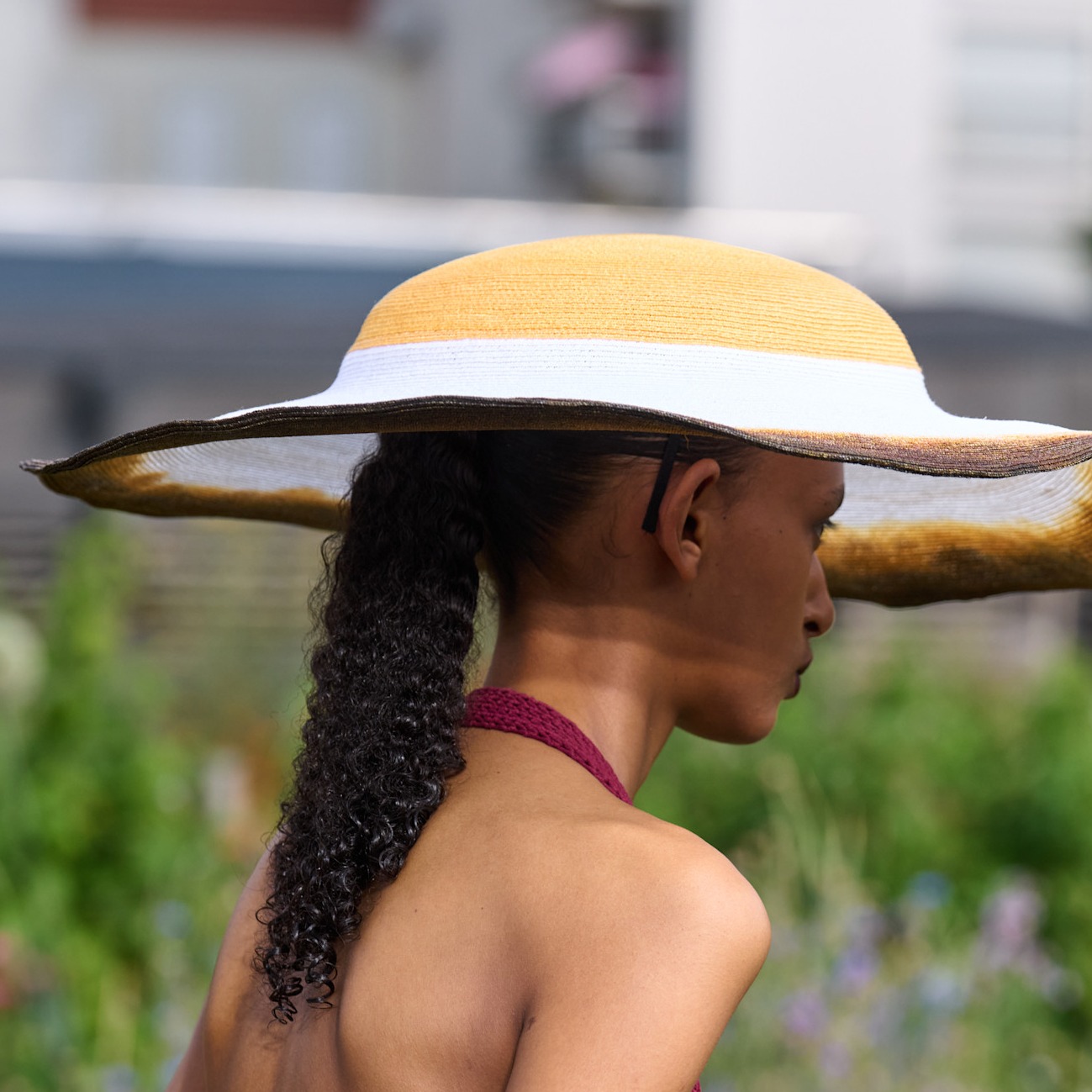 a woman walking with a hat