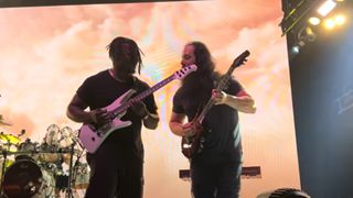 Tosin Abasi and John Petrucci playing on stage together