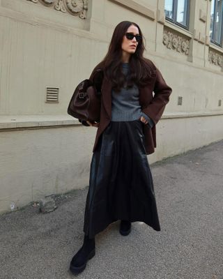 Annabel Rosendahl wearing a sweater and leather midi skirt