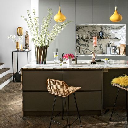 kitchen with grey walls wooden flooring and brown cabinet
