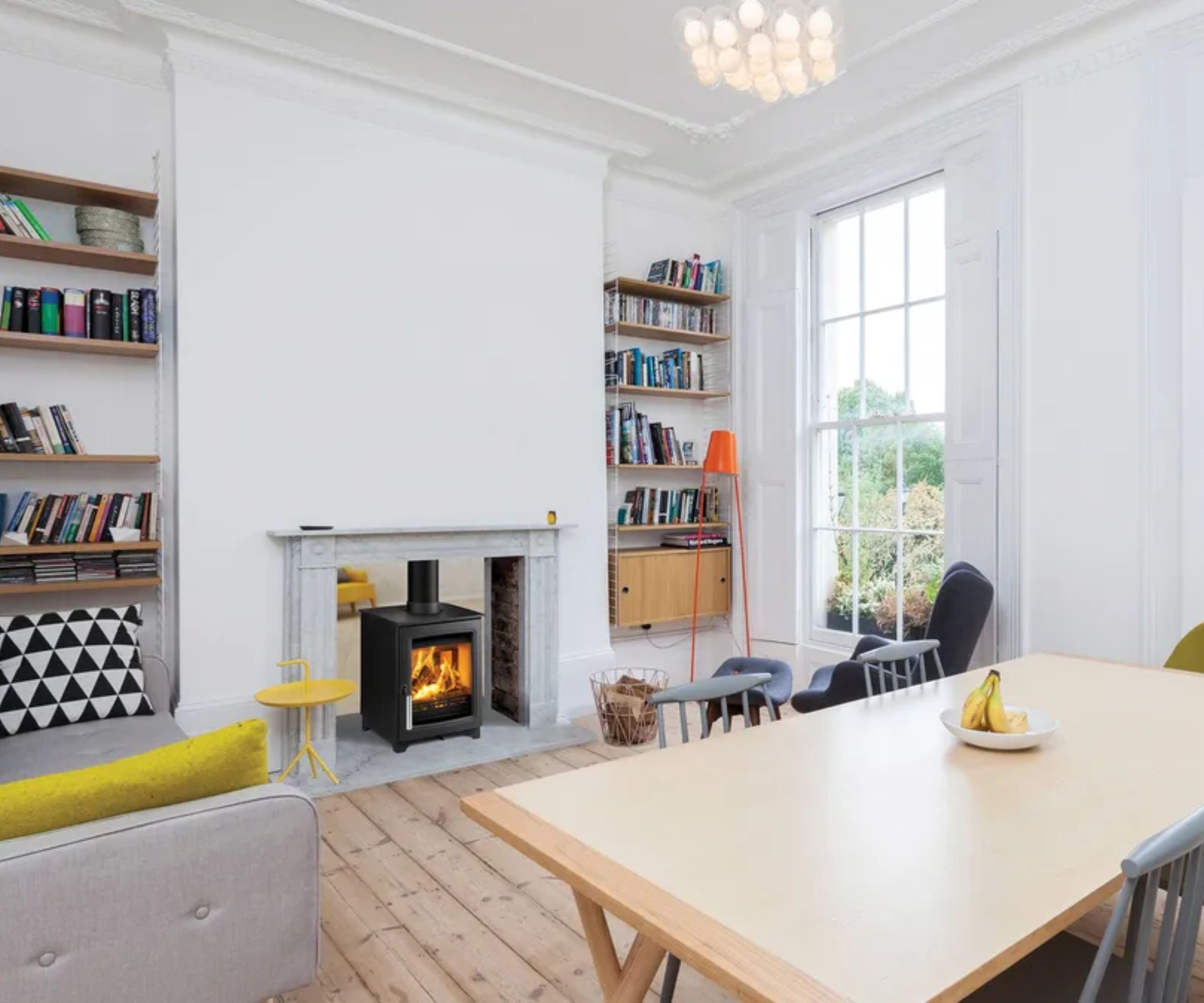 A double sided log burner separating a dining room and a living room