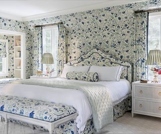 blue and white floral wallpapered bedroom with matching upholstery