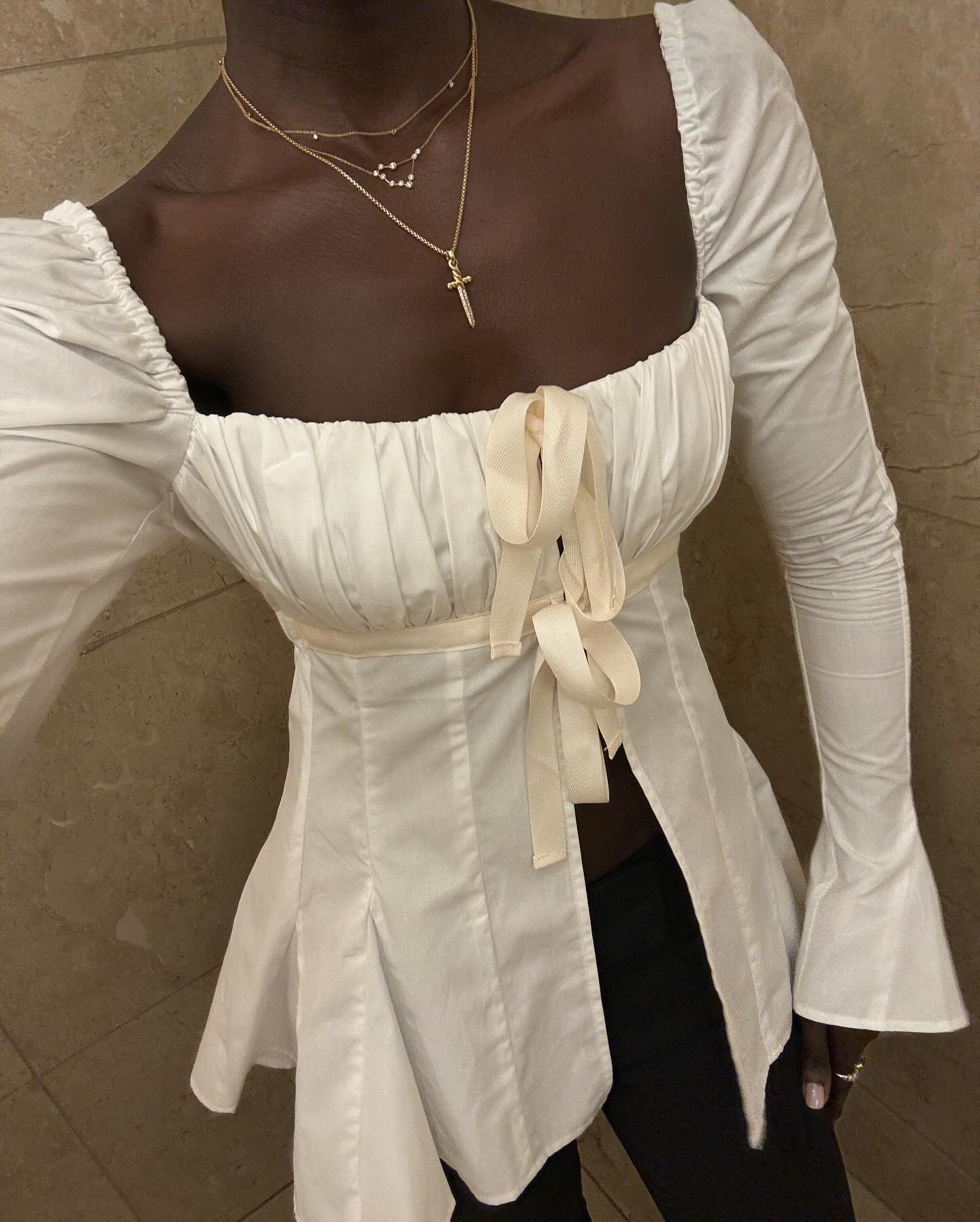 Influencer wears a top with elongated cuffs.