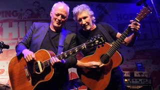 David Gilmour (L) and Roger Waters (R) perform at a benefit evening for The Hoping Foundation on July 10, 2010 in London, England