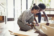 Couple building flatpack furniture