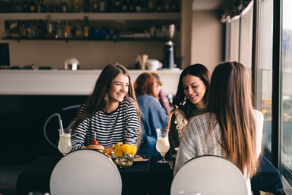 Group of friends hanging out, smiling.