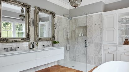 White bathroom with silver mirrors and storage