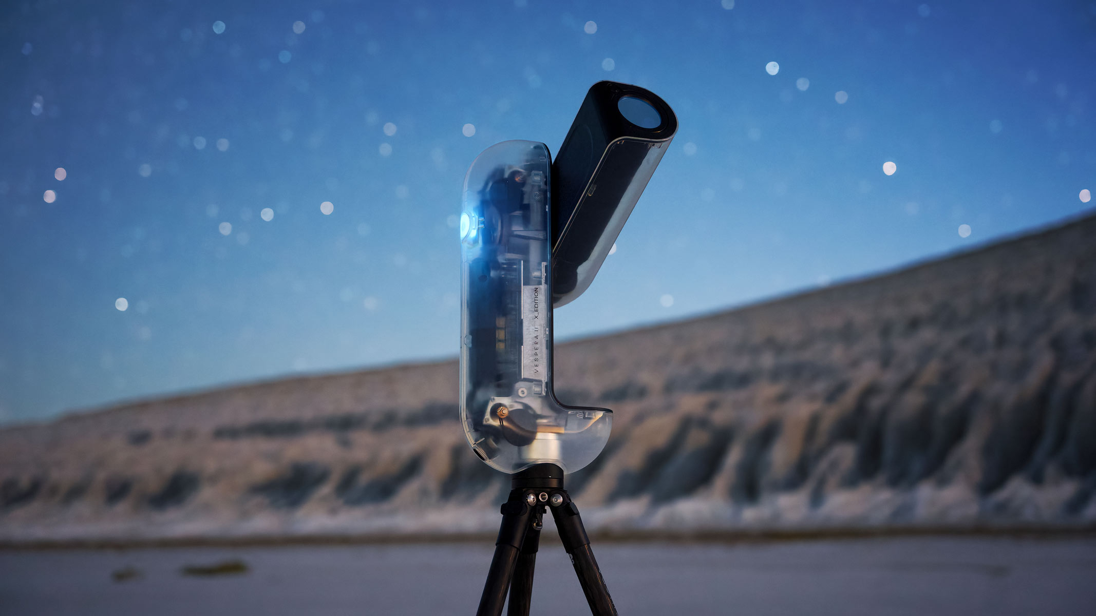 The Vaonis Vespera II - X edition pointing at the sky with a hill and starry night in the background.