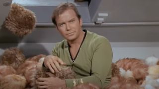 Captain Kirk surrounded by Tribbles and looking absolutely sick of it.