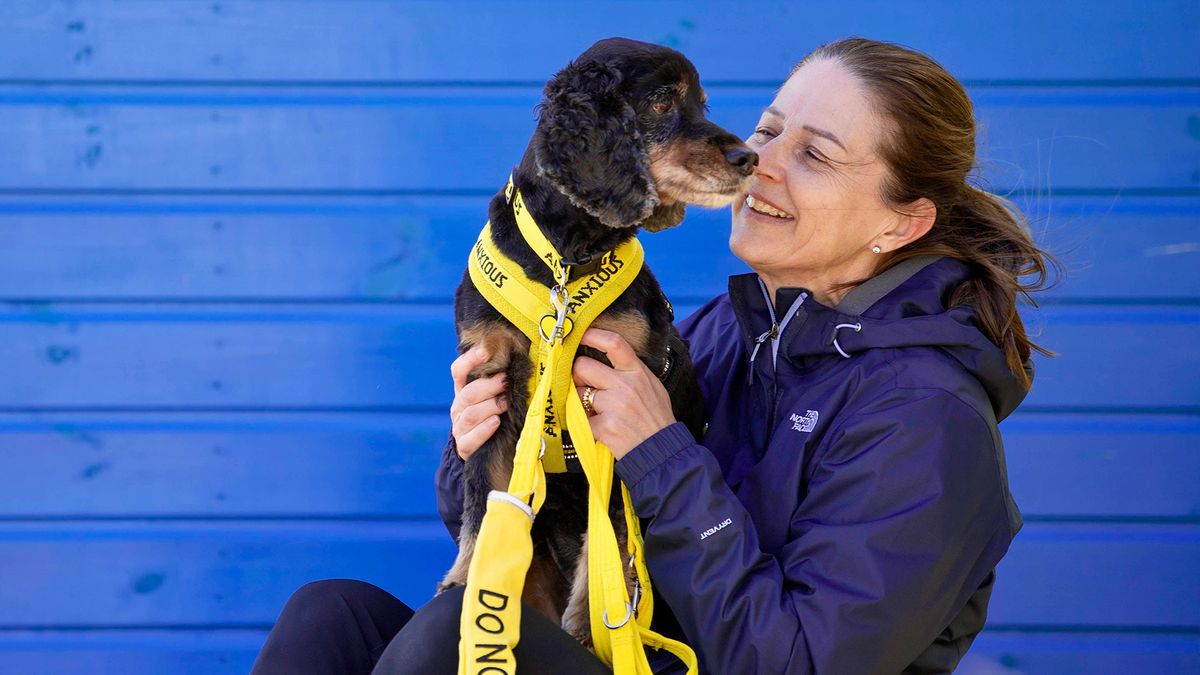 Sarah Jones with Bella who is wearing yellow anxious dog harness