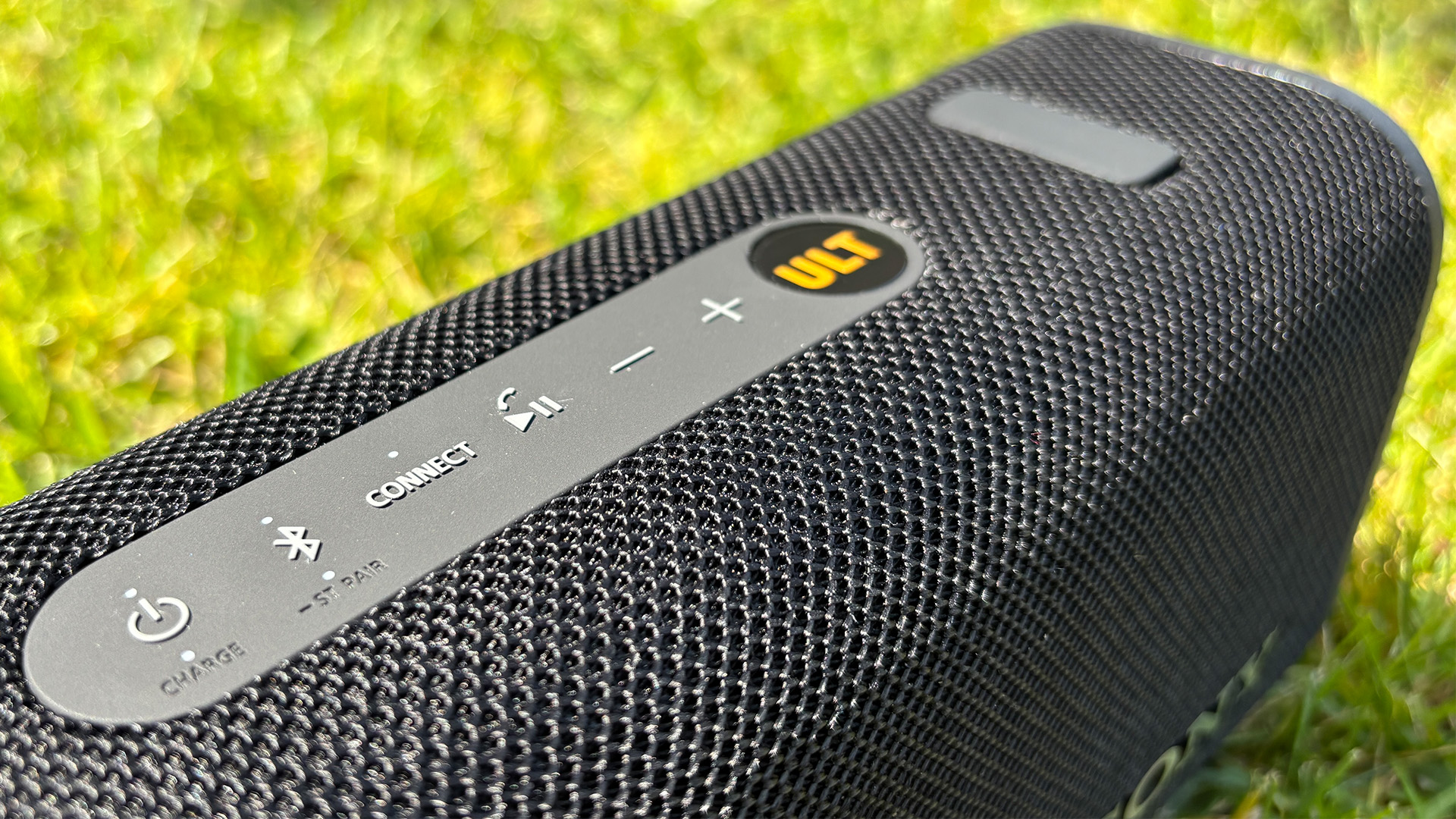 Sony ULT Field 3 wireless speaker on grassy lawn close up on control panel