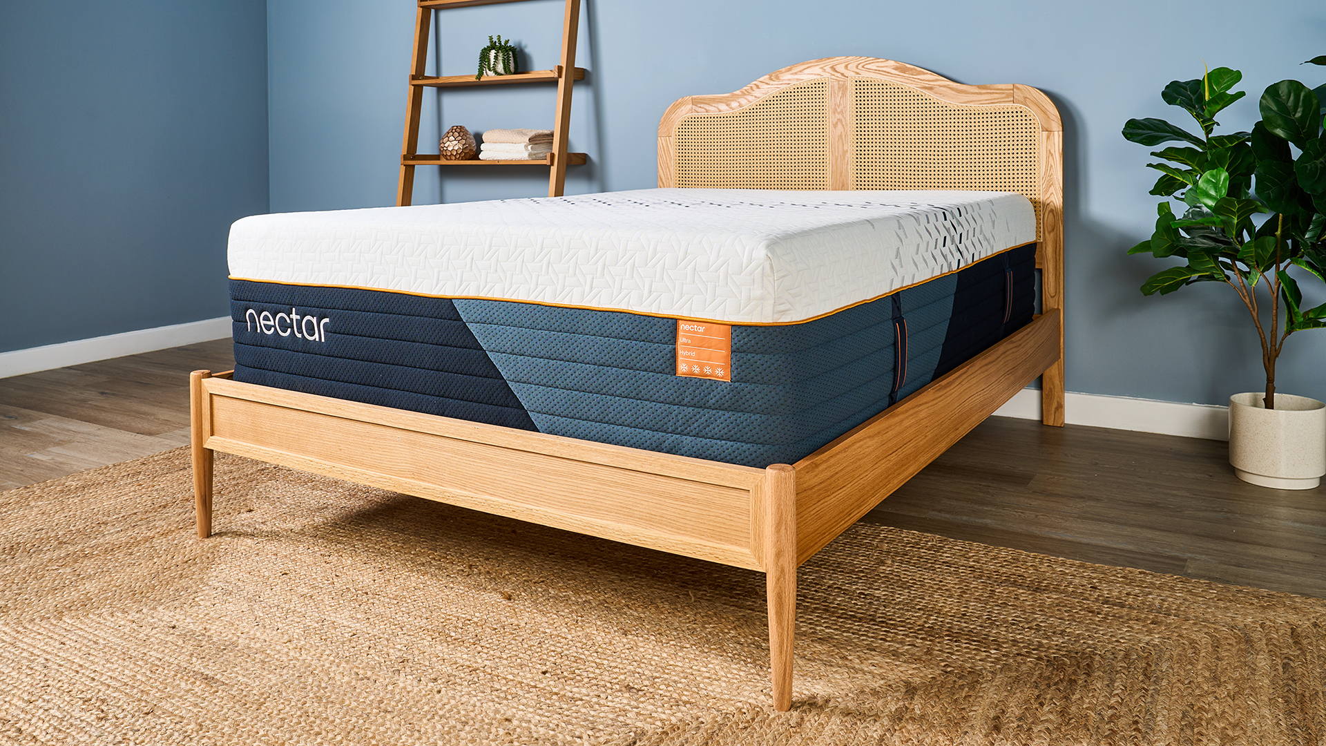 The corner of the Nectar Ultra Hybrid mattress, showing the full mattress on a wooden bed frame from a side-on angle