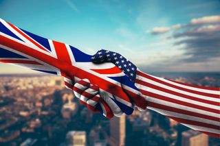 A 3D render of two hand shaking in agreement, with hands appearing to be made out out of Great Britain and US flags