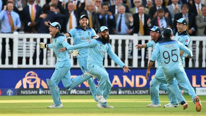 England wicketkeeper Jos Buttler celebrates with his team-mates after the win over New Zealand