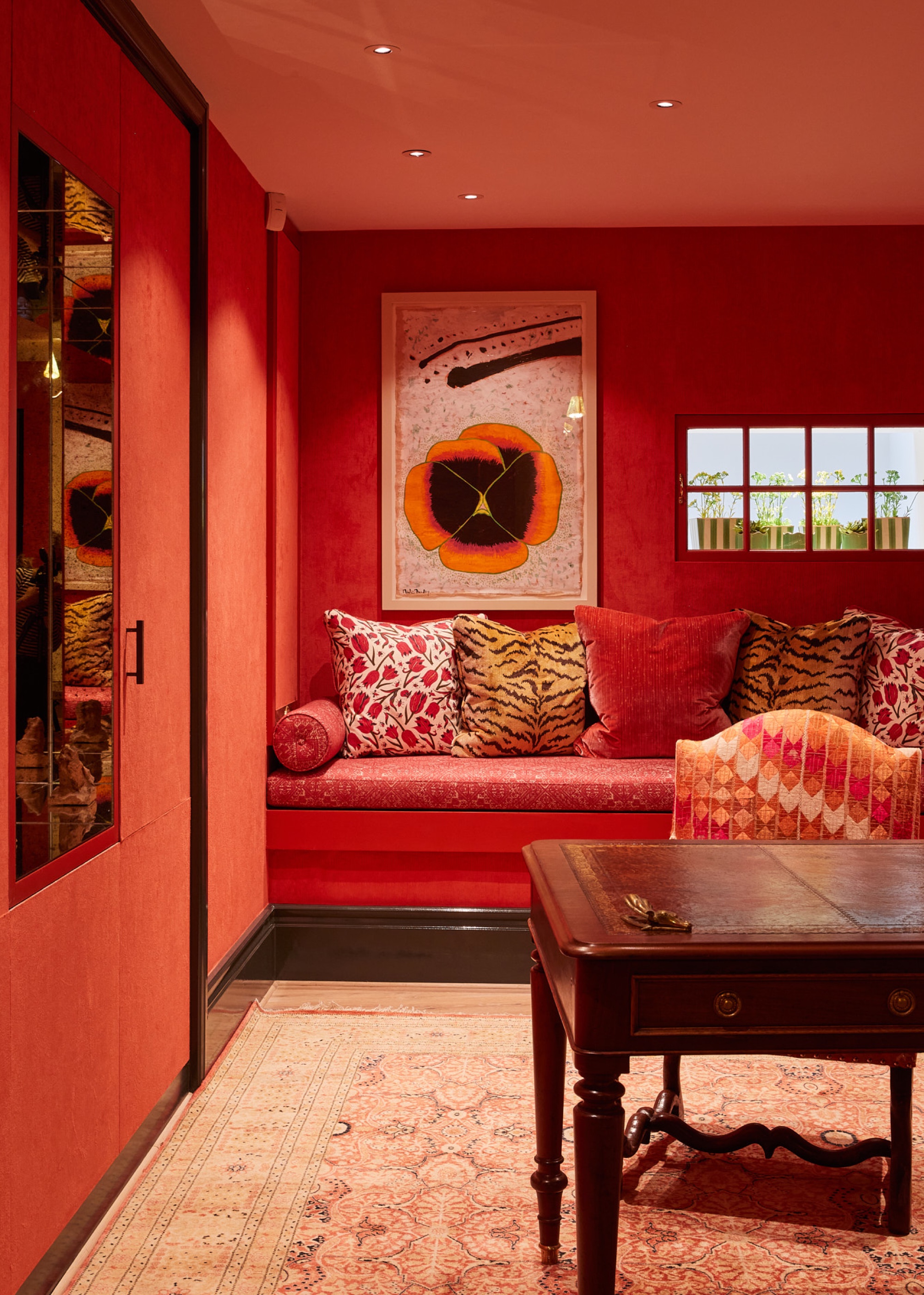 snug and home office with terracotta walls and patterned cushions by Barlow &amp;amp; Barlow