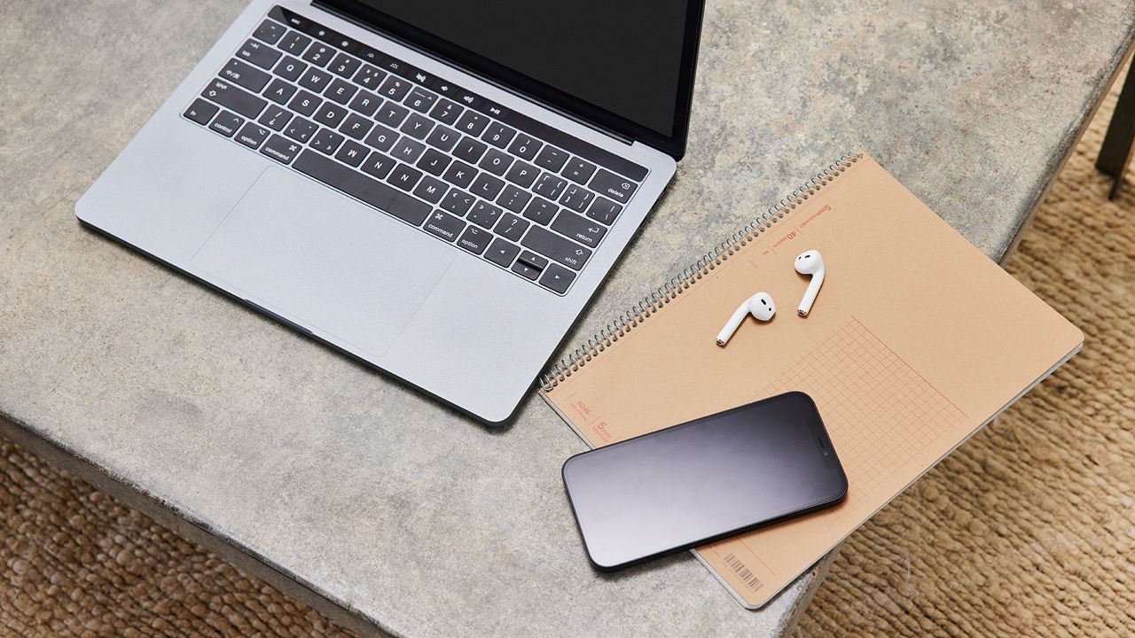 Laptop, smartphone and headphones on a table