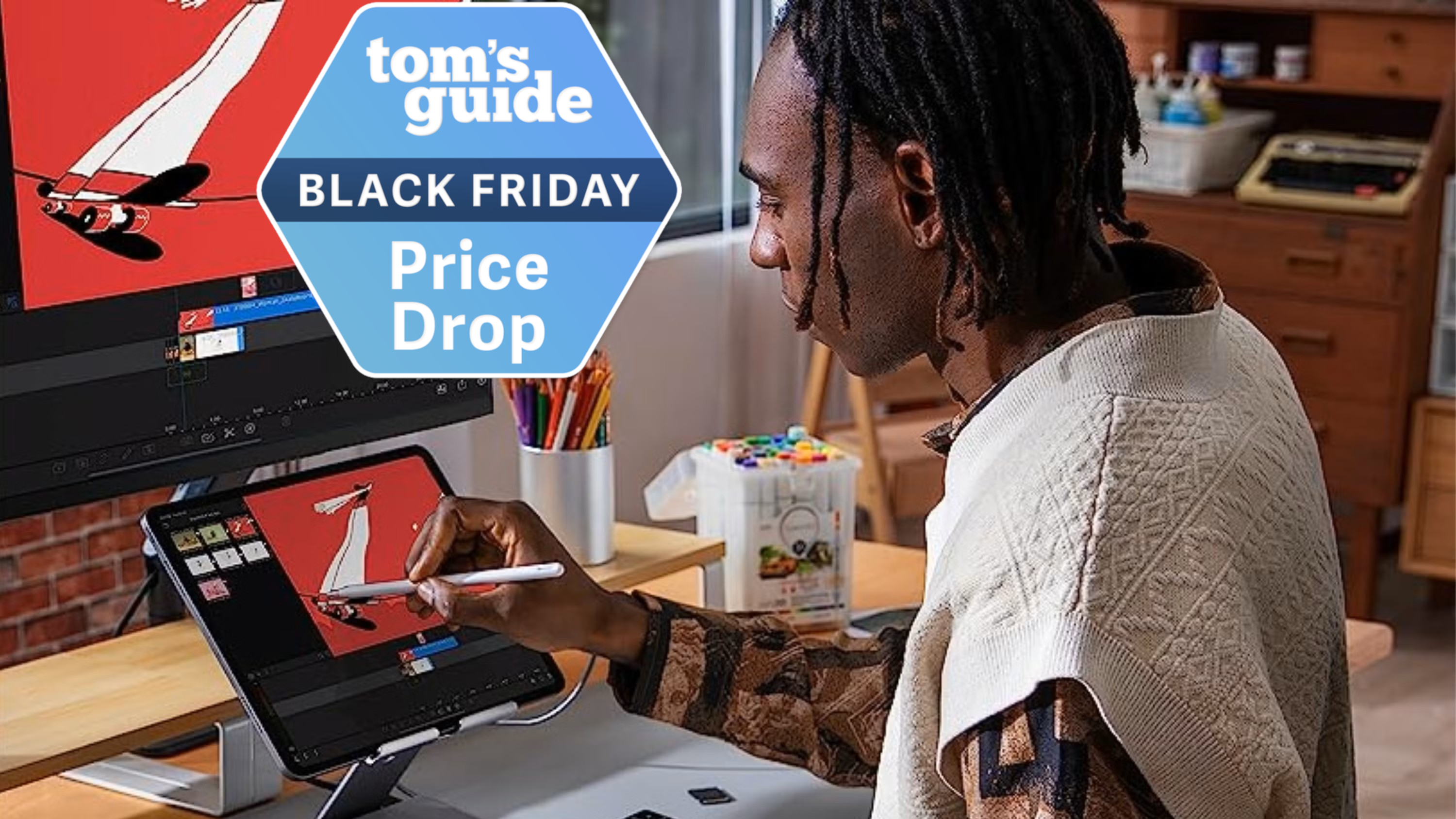 A person drawing on their iPad with it connected to a monitor with a Tom's Guide Black Friday deals badge