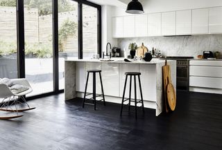 Dark Laminate in kitchen with white island/breakfast bar and sliding doors