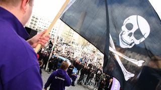 Supporters of the Pirate Bay wave flags in support of the site at a Swedish trial.