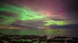 UK, Scotland, Dunbar, Long exposure of Aurora Borealis over Firth of Forth at night