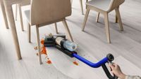 The Dyson WashG1 cleaning under a table