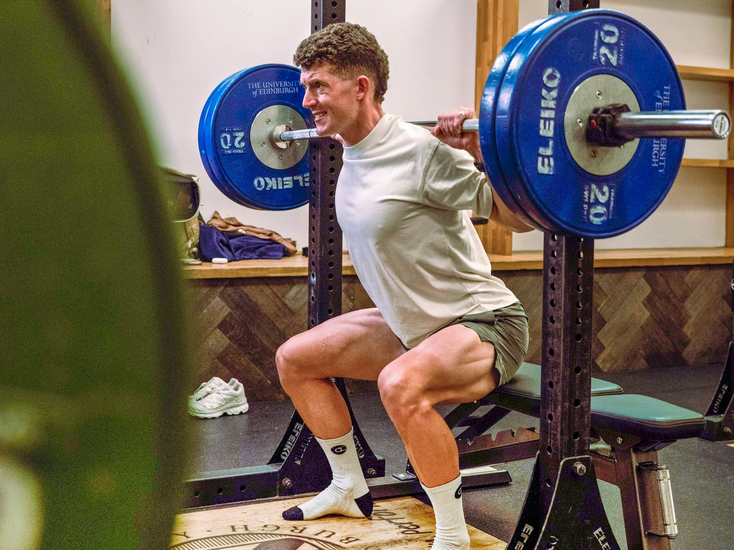 Cyclist squatting in the gym