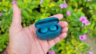 Hero image for the best cheap earbuds showing the JLab Go Air Pop held in hand