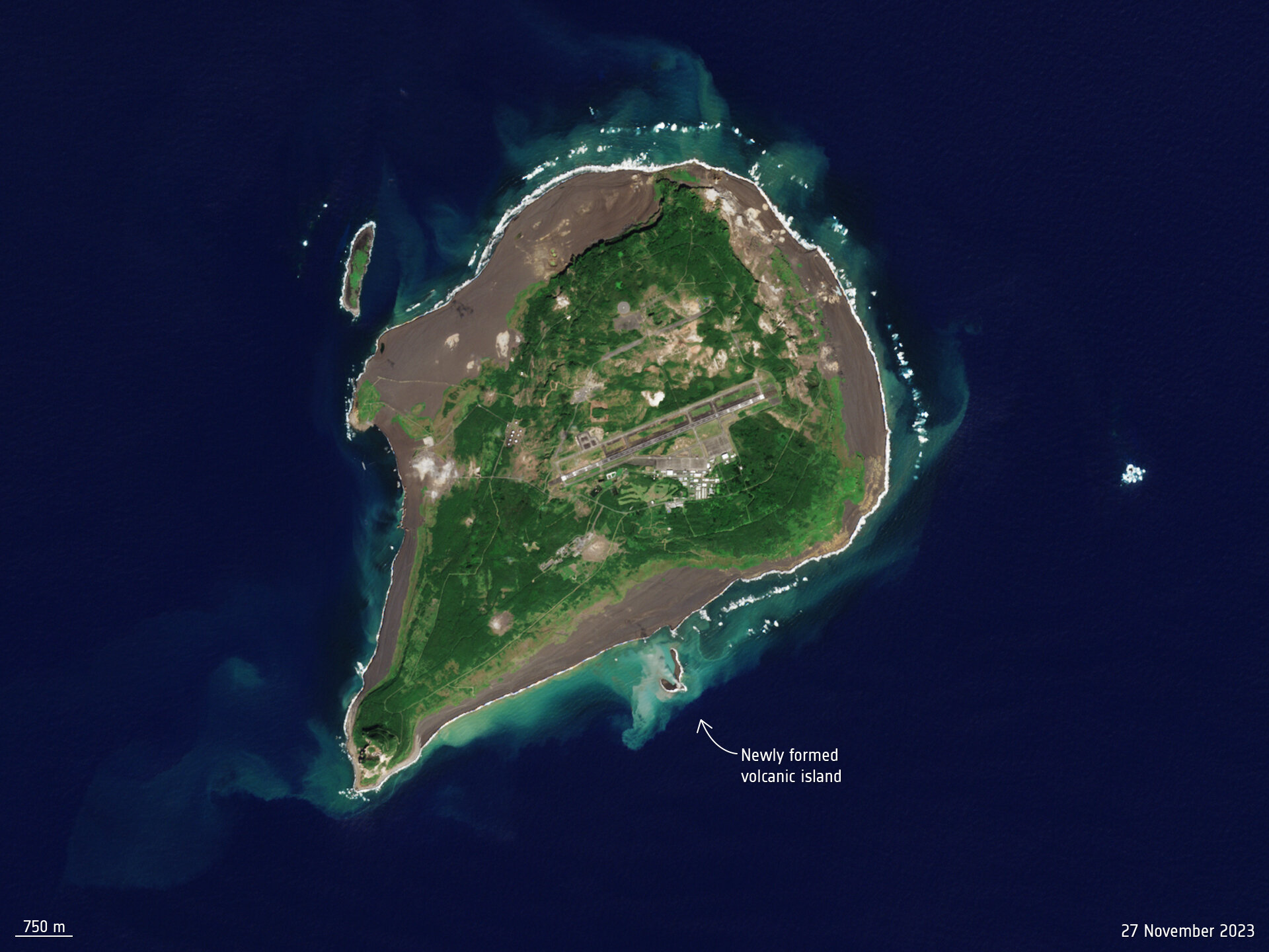 a satellite view of a large island with a smaller island forming off of its coast