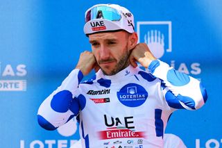 PADRON SPAIN AUGUST 28 Adam Yates of The United Kingdom and UAE Team Emirates celebrates at podium as Polka Dot Mountain Jersey winner during the La Vuelta 79th Tour of Spain 2024 Day 11 a 1665km stage from Padron to Padron UCIWT on August 28 2024 in Padron Spain Photo by Tim de WaeleGetty Images