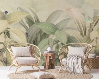 Relaxed boho living space with cocoon woven chairs, round jute rug, and large-scale leaves wall mural.