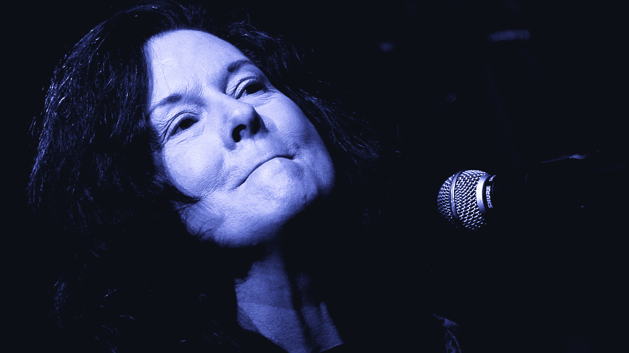 Linda Gail Lewis, mid-song, in front of a microphone.