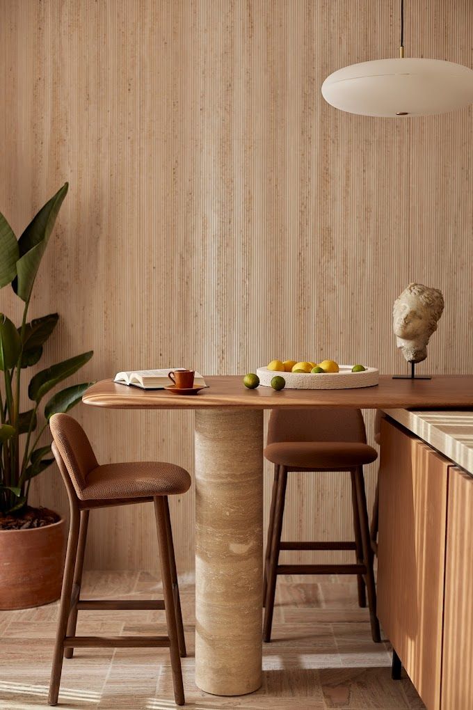 A superbly designed suite features modern rustic-meets-brutalism interiors, with wood, cement, and marble accents as well as plants all merging into the same room.