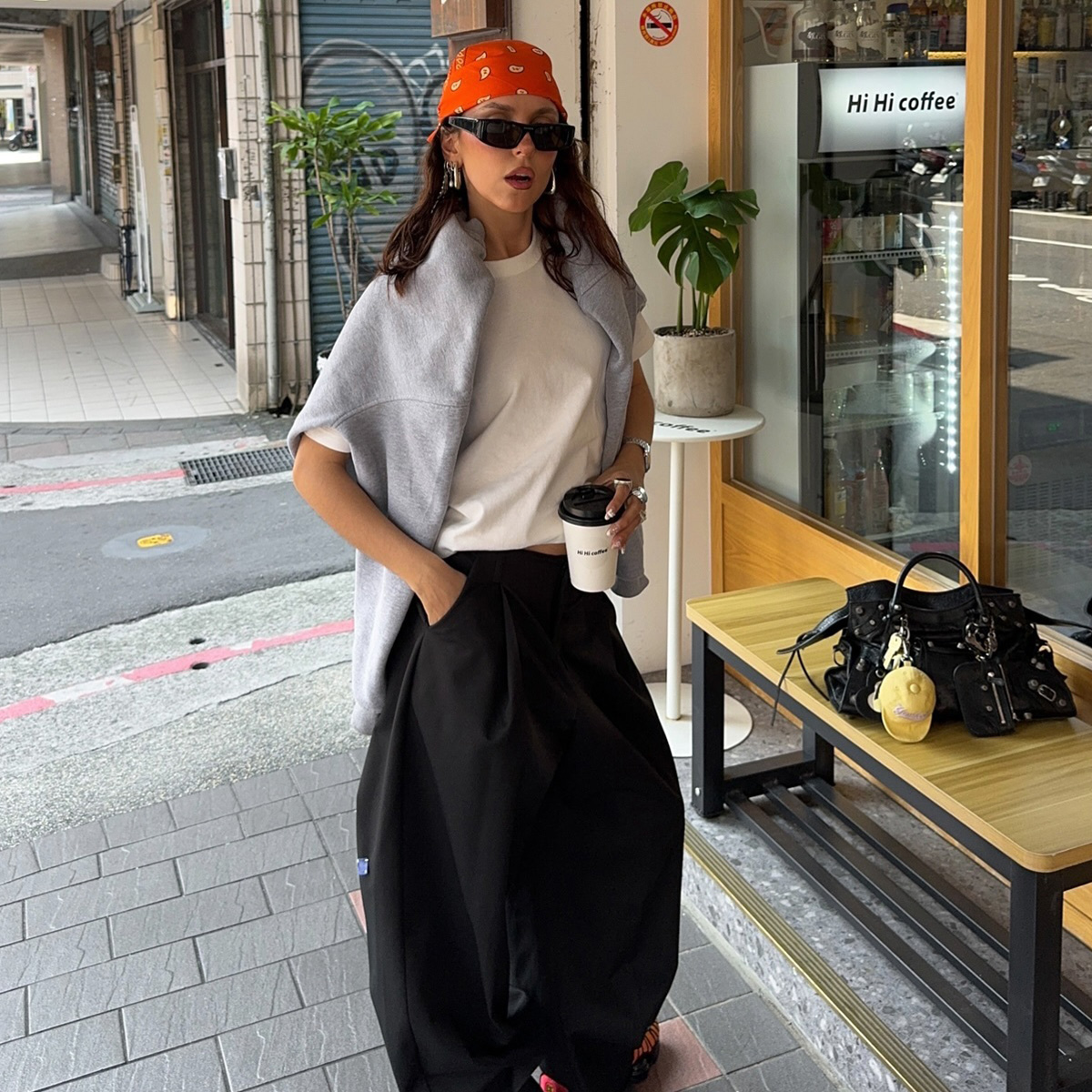 Sofia wears trousers, Nike Shox, and a bandana.