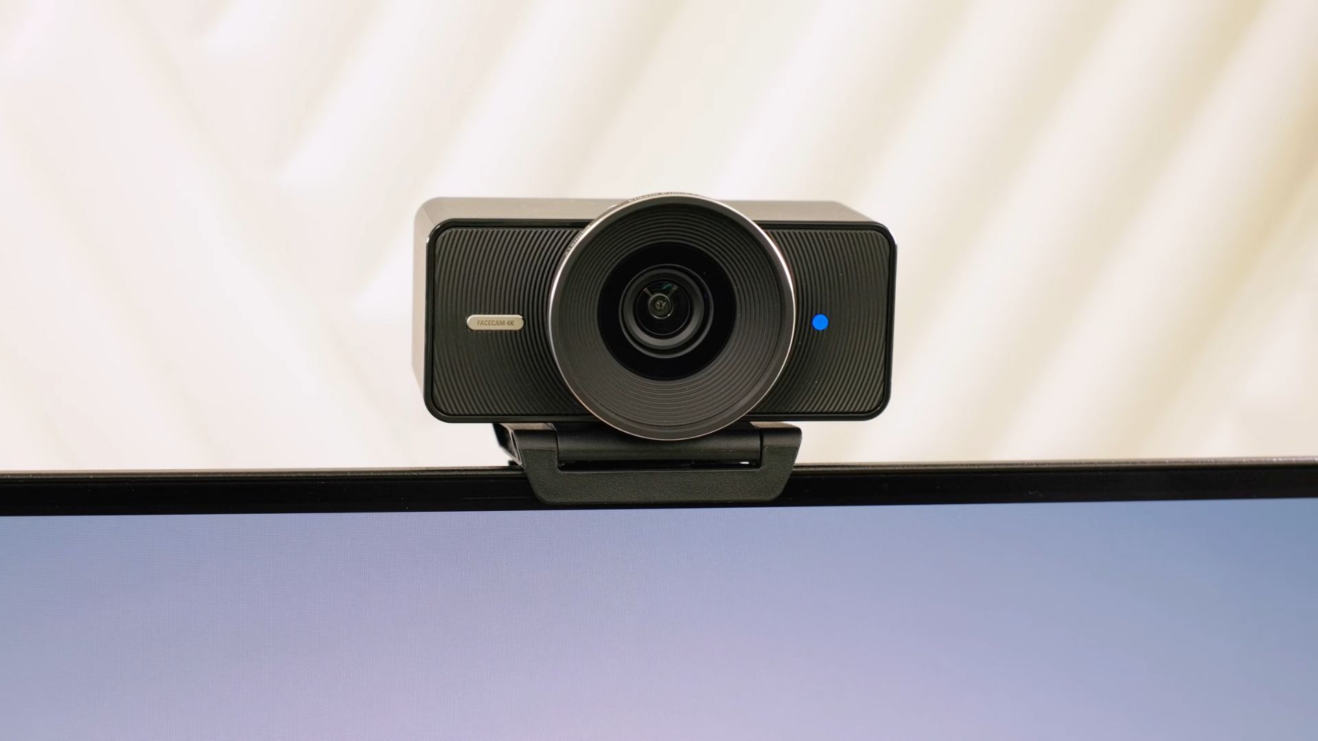 The Elgato Facecam 4K sitting on top of a monitor
