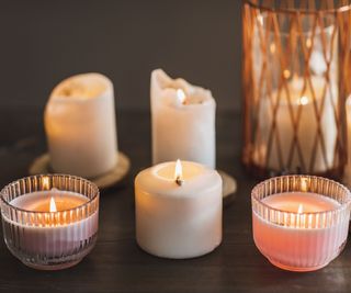 A range of candles in different vessels