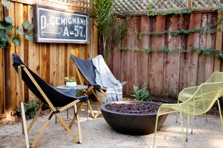 An outdoor chalk board in a patio area with firepit