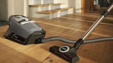 Miele Blizzard CX1 Cat & Dog canister vacuum on wooden floor