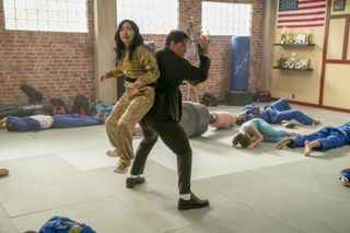 Awkwafina strapped to John Cena's back in one of many fun Jackpot! stunt sequences.