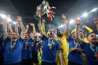 Italy players celebrate with the Henri Delaunay Cup after winning Euro 2020