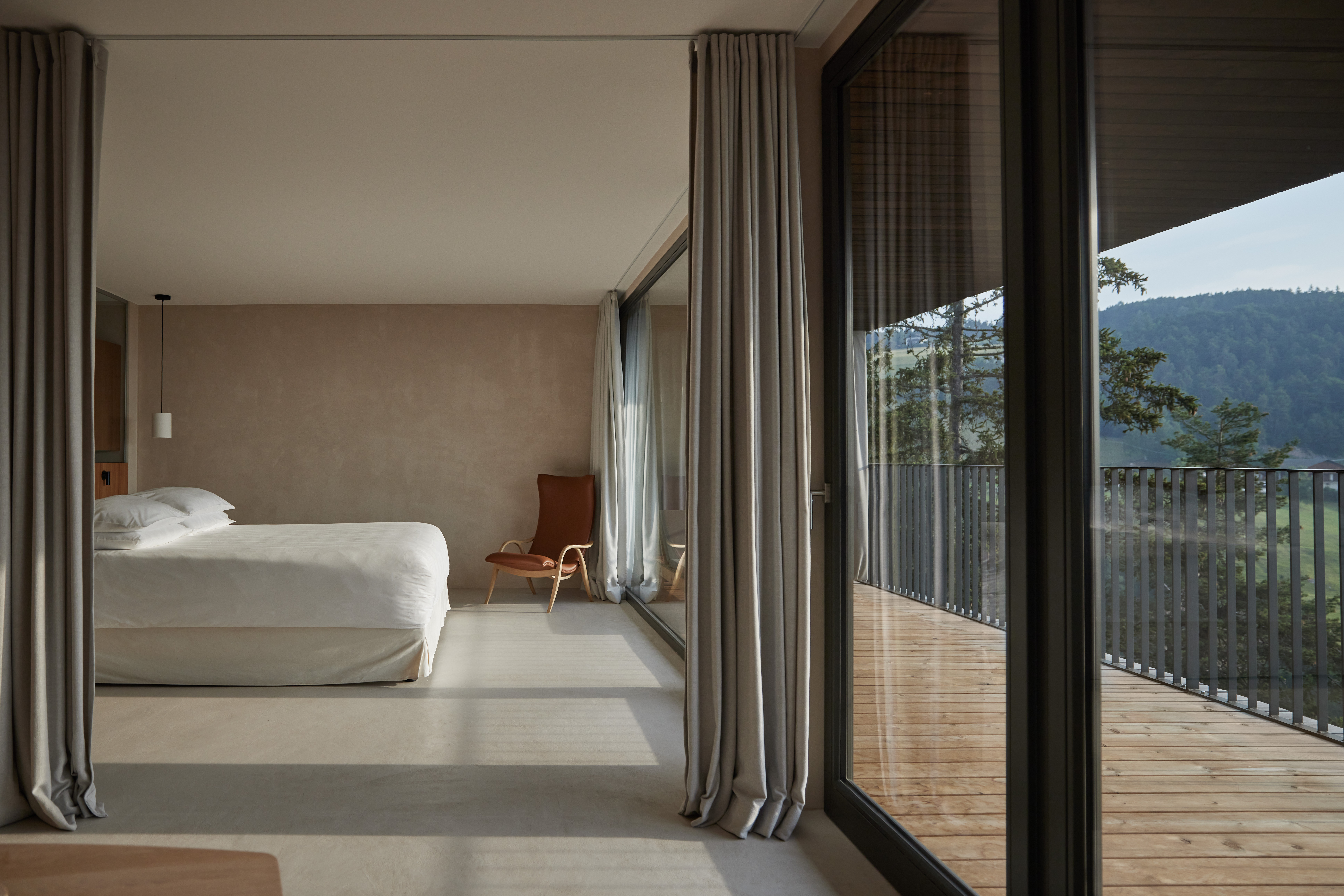 A mountain-view hotel room with minimalist decor.