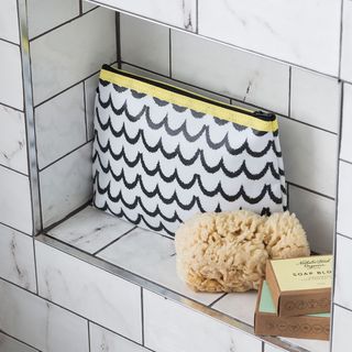 white brick tiles storage with soap boxes and bag