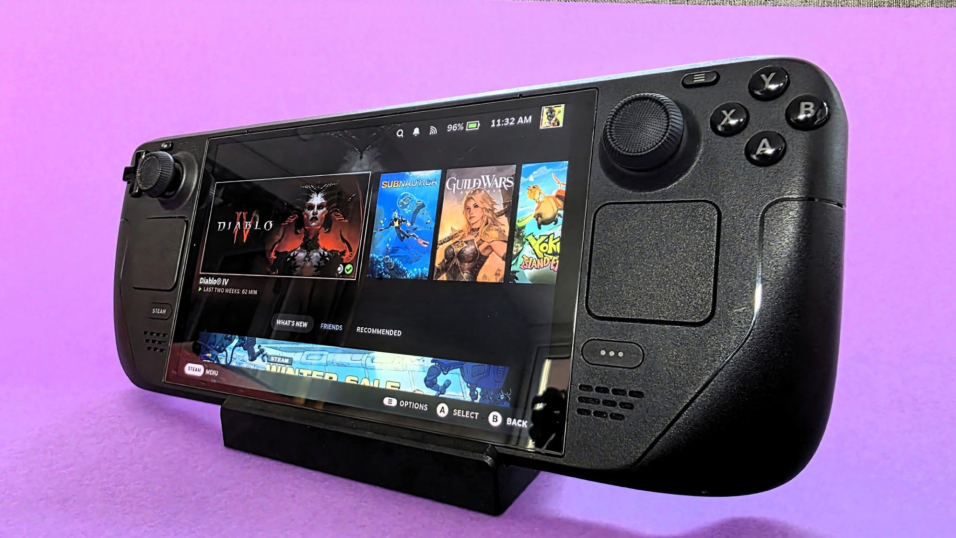 A Steam Deck OLED handheld gaming console on a solid purple background