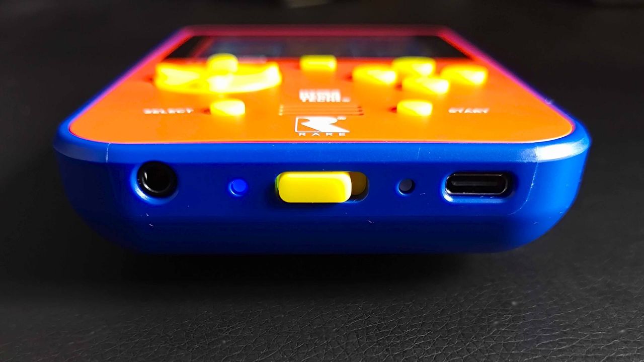 Bottom view of Super Pocket Rare Edition with USB-C, power switch, and headphone jack on black desk.