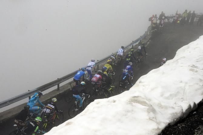 The peloton struggled through snow and rain on stage 16 of the Giro d'Italia