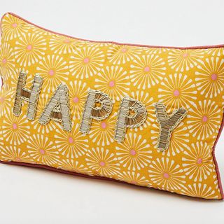 yellow cushion with floral design